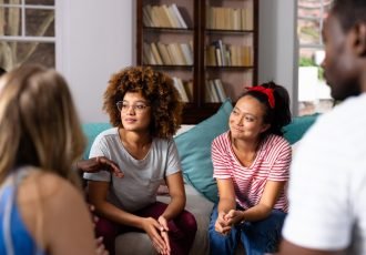 Supportive,Diverse,Friends,Smiling,And,Listening,To,Each,Other,At