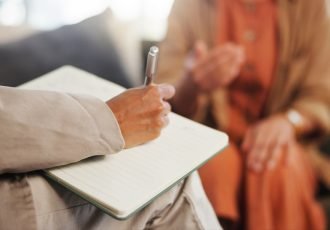 Book,,Counseling,And,Hand,Of,Therapist,Writing,Notes,For,Client
