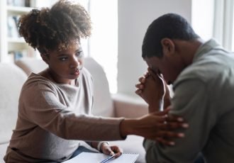 Friendly,Beautiful,Black,Woman,Therapist,Consoling,Upset,Young,Man,,African